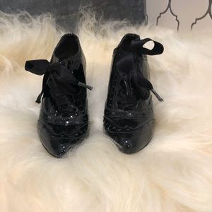 Elegant patent leather wingtip shoes.